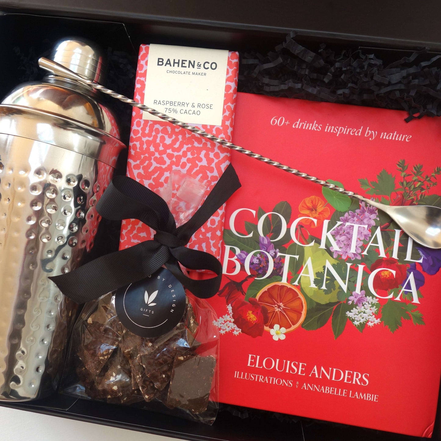 Nature inspired cocktail gift hamper featuring cocktail shaker, recipe book, and gourmet treats.
