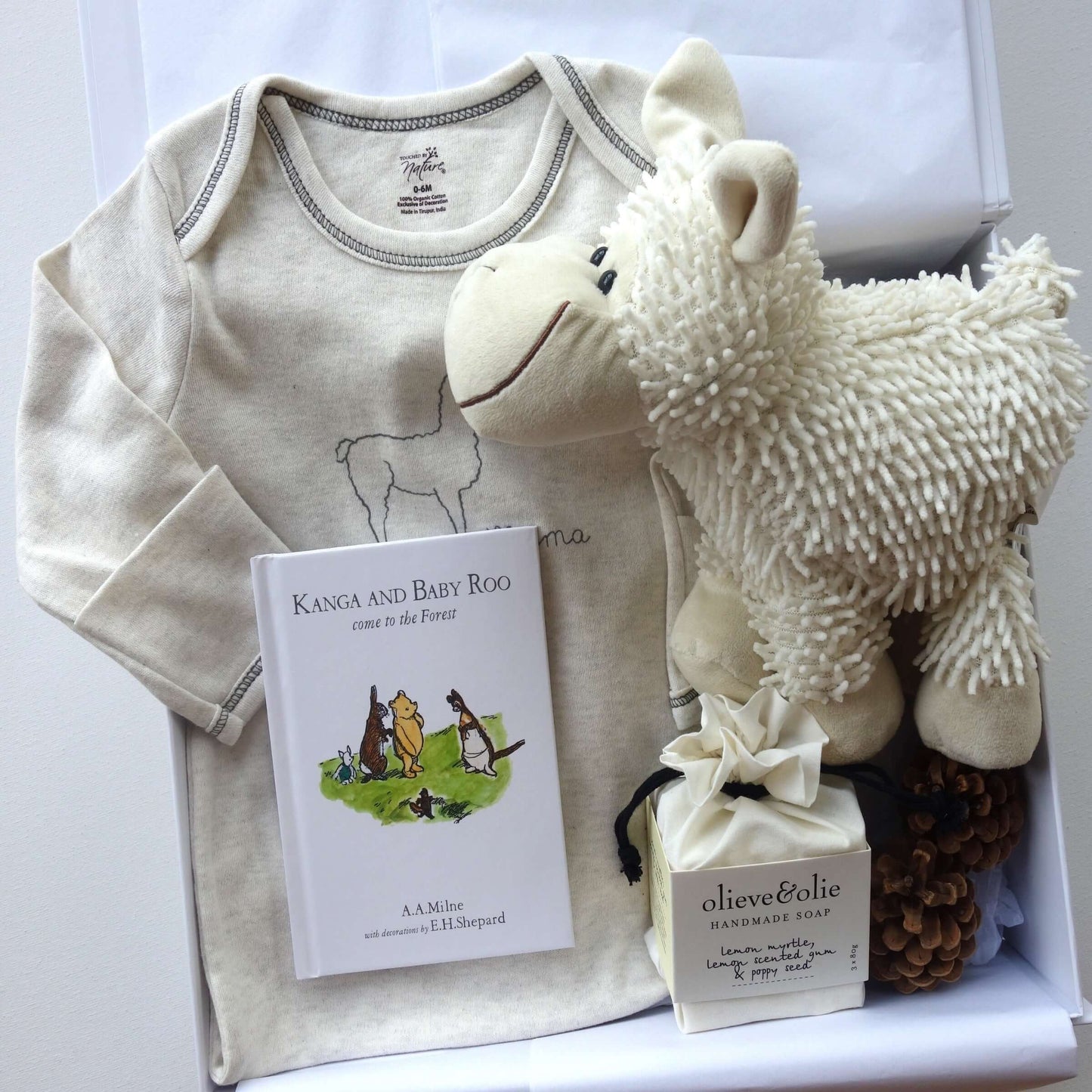 Unisex baby gift box featuring organic cotton sleepsuit, soft sheep toy, and Kanga and Baby Roo storybook.