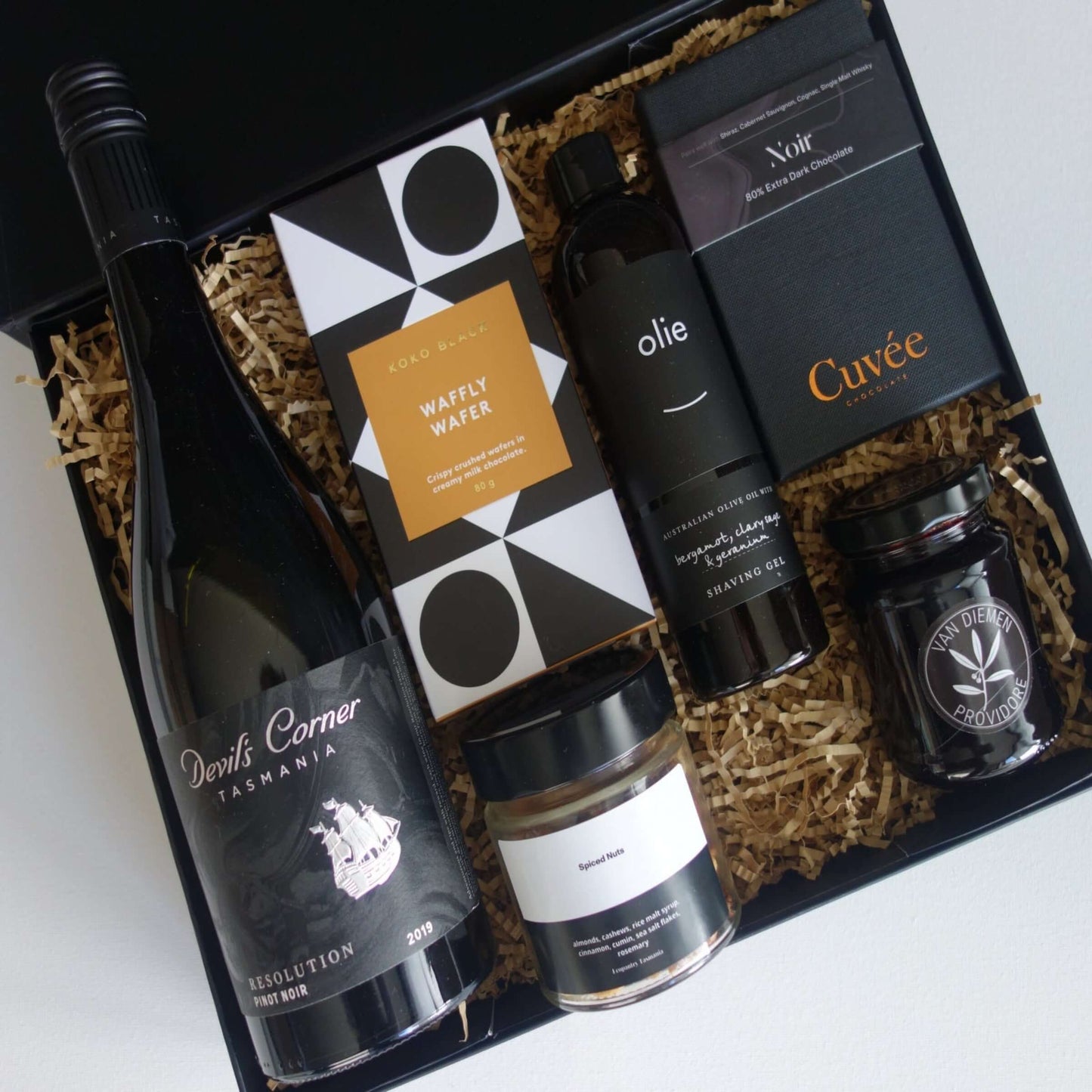 The Monochrome Men's Hamper featuring Tasmanian wine, gourmet snacks, and luxury grooming products.