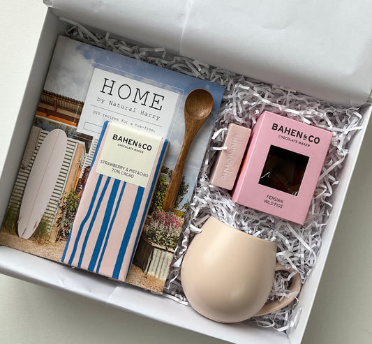 Natural Home gift hamper featuring a book, mug, chocolate