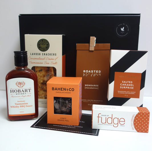 Tasmanian gourmet gift hamper featuring Hobart Whisky BBQ Sauce, lavosh crackers, Bahen & Co chocolate, and more.