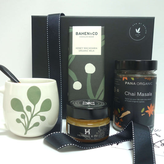 Chai Time gift set featuring organic honey macadamia milk, chai masala, and a ceramic mug for relaxation and enjoyment.