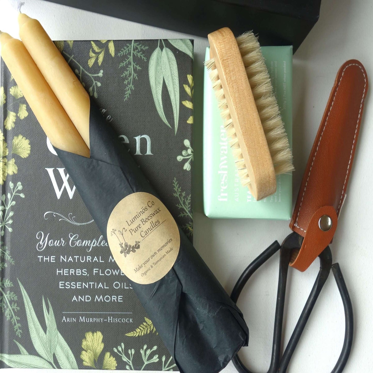 Gardening Gift Hamper including candles, nail brush, soap, garden scissors, and a book on herbs and flowers.