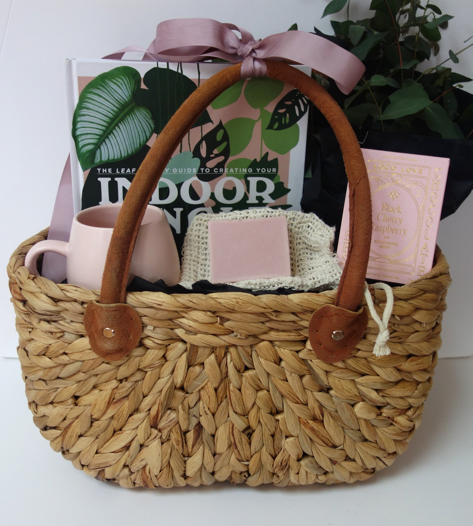 Just For You Gift Basket featuring a guide book, lavender soap, chocolates, a mug, and decorative plant.