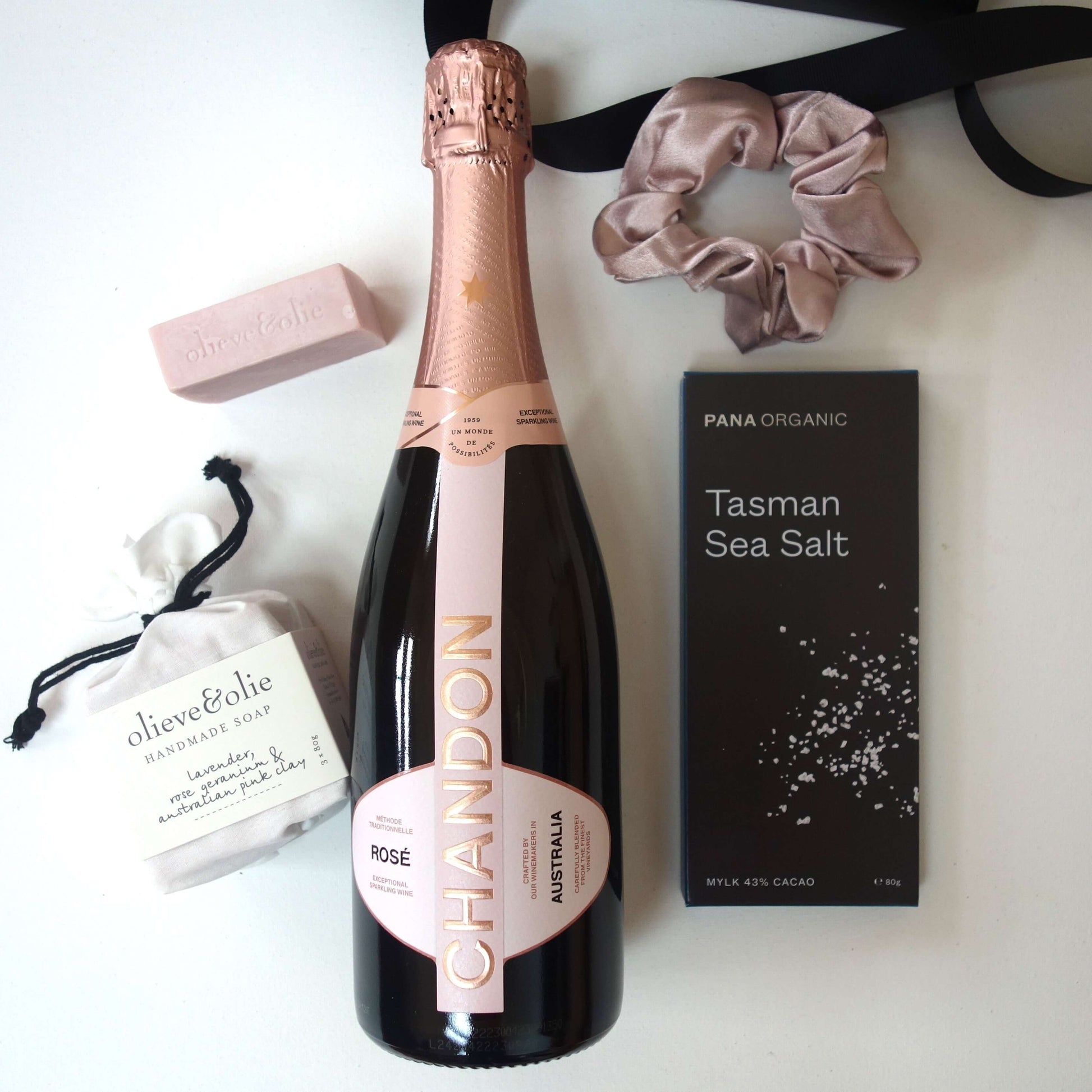 Indulgence gift box featuring Chandon Sparkling Rose, Tasman sea salt chocolate, pink soap, and blush satin scrunchie.