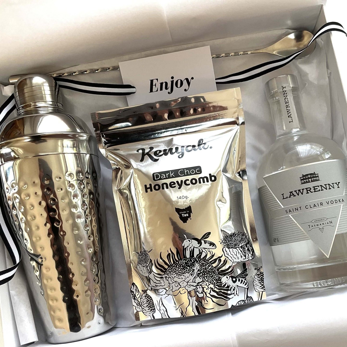 Tasmanian let's celebrate gift box featuring a cocktail shaker, dark chocolate honeycomb, and vodka.