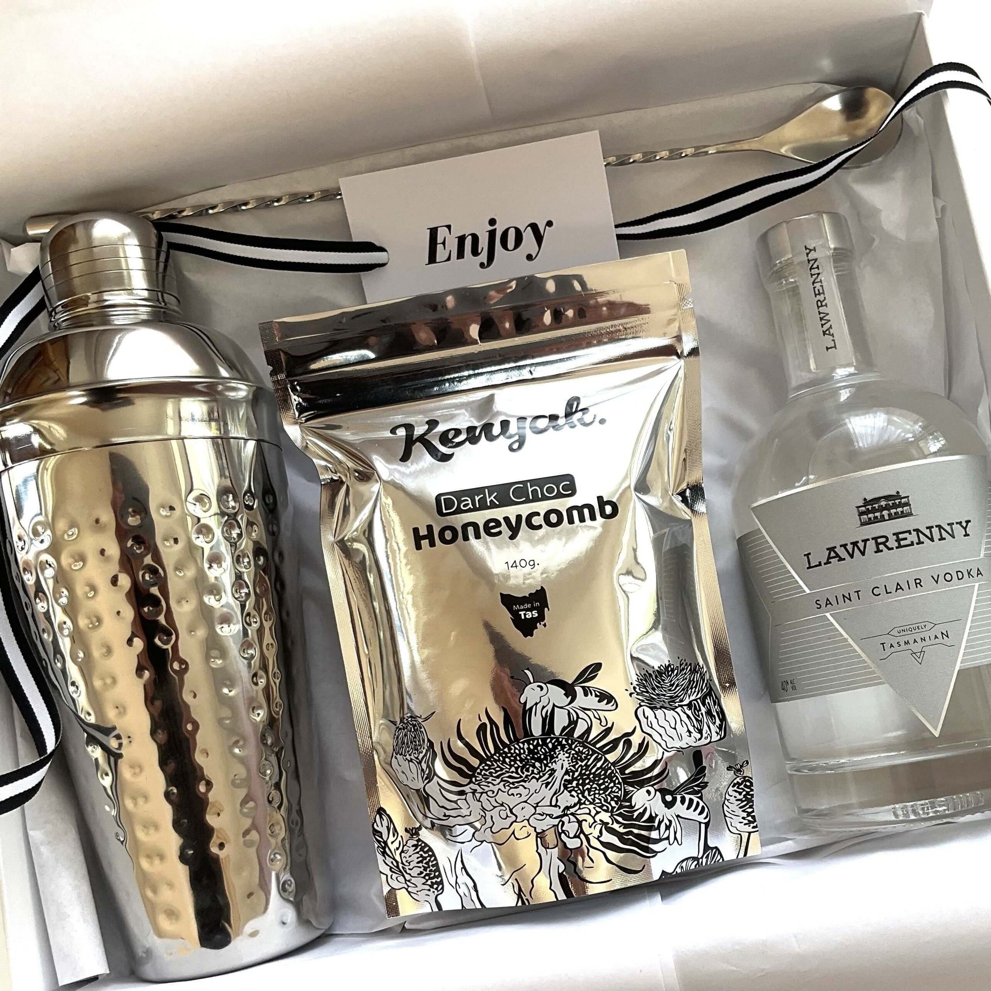 Tasmanian let's celebrate gift box featuring a cocktail shaker, dark chocolate honeycomb, and vodka.