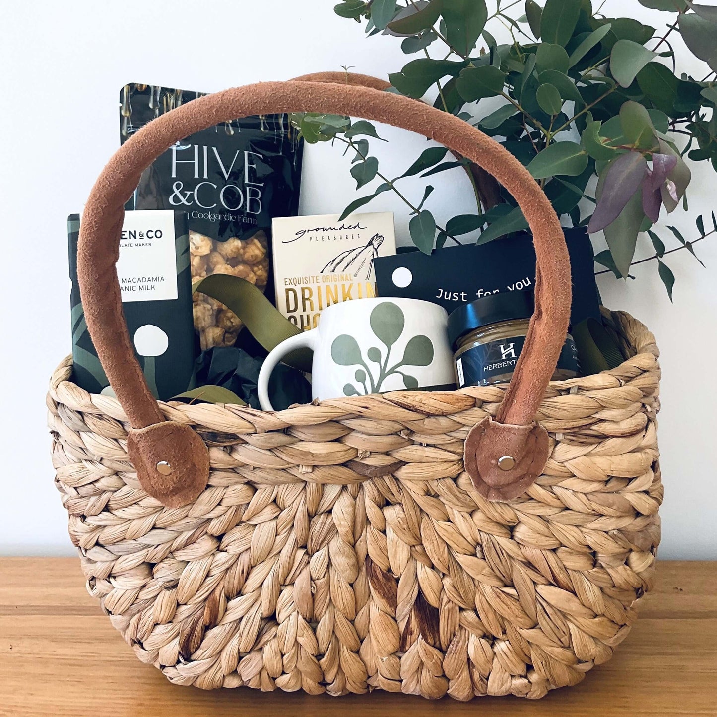 Luxury gift basket for her filled with gourmet treats, a mug, and decorative items for special occasions.