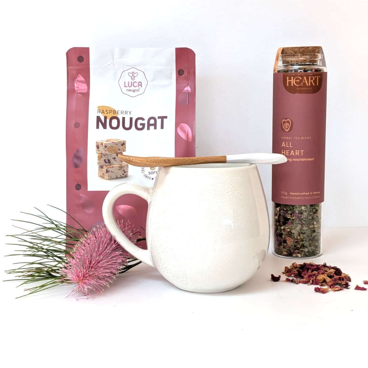 Sweet treats and quiet moments featuring raspberry nougat, a ceramic mug, and herbal tea blend for relaxation.