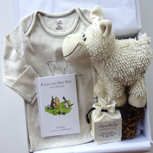 Unisex baby gift box featuring organic cotton sleepsuit, soft sheep toy, and Kanga and Baby Roo storybook.