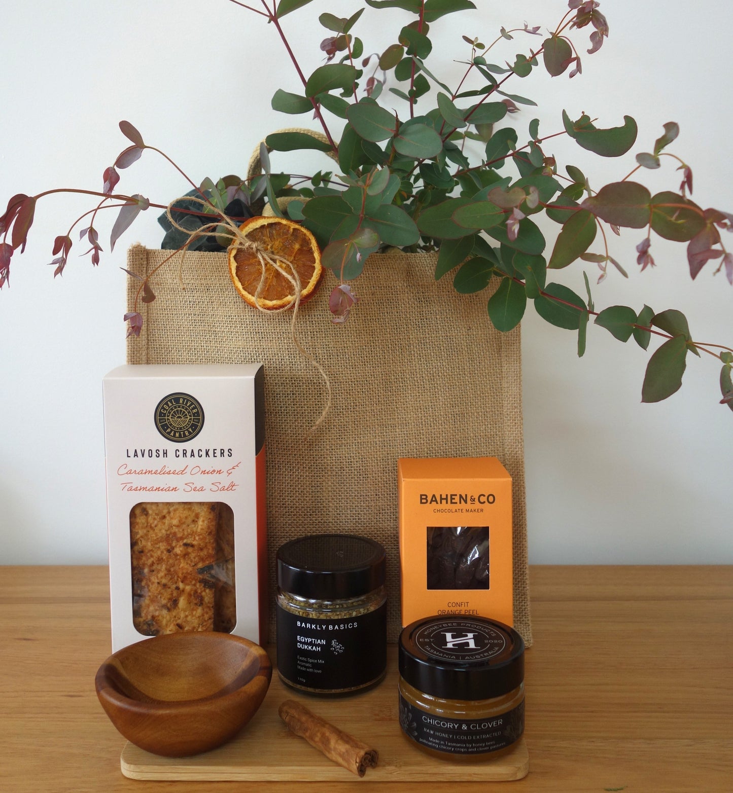 Thank you gift hamper Tasmania featuring Lavosh crackers, honey, chocolate, spices, and a jute bag with botanic greenery.